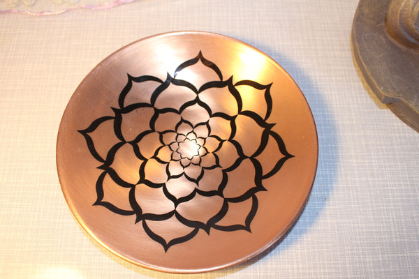 This beautiful copper plate will look lovely anywhere you display it. Six inches in diameter with a lotus symbol on it.  cost  35.00 dollars 