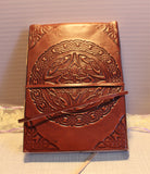 Embossed leather with different symbols such as Celtic, dream catcher or Lotus flower. All have a red hue to the cover. All journals are 5x7 in size and have blank papers inside. 32.00 dollars per journal