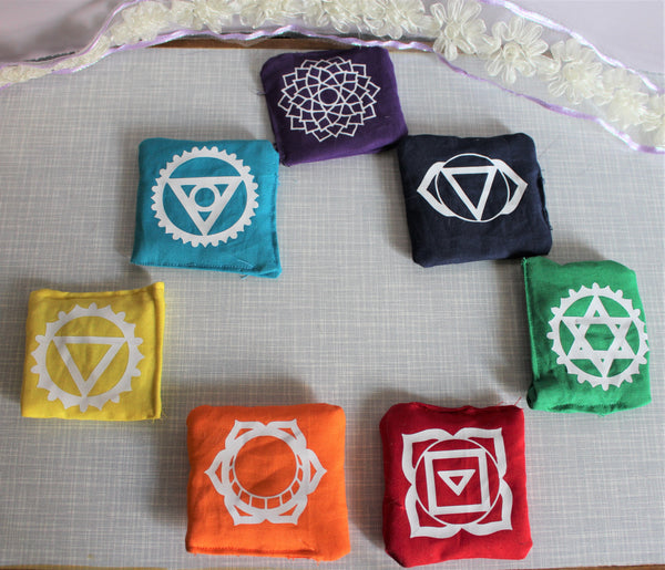 One set of 7 chakra pillows. One for each chakra, root, sacral, solar plexus, heart, throat, third eye and crown.   Each pillow is colour coded and infused with crushed clear quartz crystals to help enhance the power of the pillows. The pillows are approximately three inches squared, with the appropriate chakra symbol. Each pillow is handmade so sizes and shapes may not be perfect.  35.00 dollars for the set 