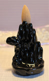 The black cave back flow incense holder is 3.25 inches or 8.5 cm in height. 2 inches or 5cm at the base. 15 dollars