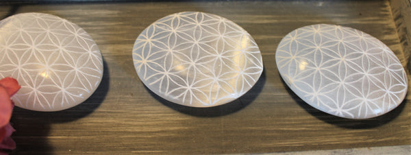Selenite palm stone with carved flower of life pattern. 2.5 inches or 5 cm in size. $20.00 per piece 